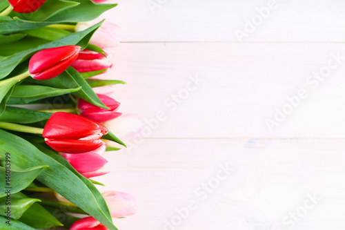 Fototapeta Naklejka Na Ścianę i Meble -  Bouquet of pink tulips on white wooden background. Top view, copy space. Happy mother's day.