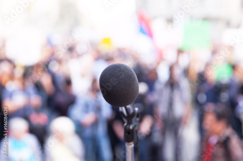 Microphone in focus, against blurred crowd © wellphoto