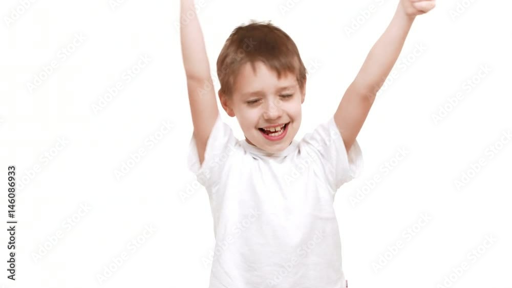 Cute elementary-school aged Caucasian boy smiling on white background and waving hands showing ok Cute elementary-school aged Caucasian boy smiling on white background and waving hands showing ok