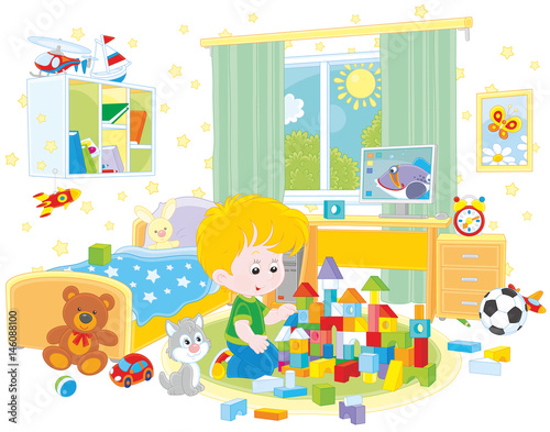 Little boy playing with bricks in his room