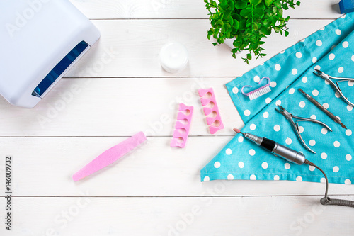 Different Beauty and Personal Care Hardware pedicure and manicure Feet Hand Nail tools and Accessories on white placed on table. photo