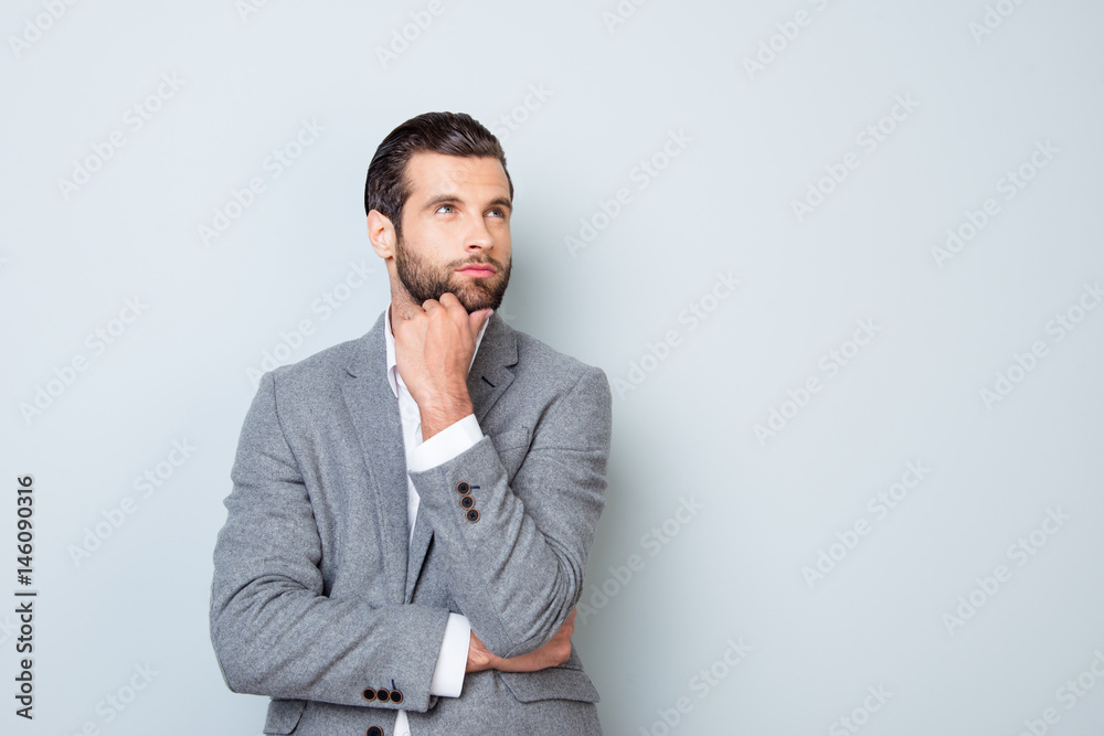 Minded handsome young man planning how to launch a new project Minded handsome young man planning how to launch a new project