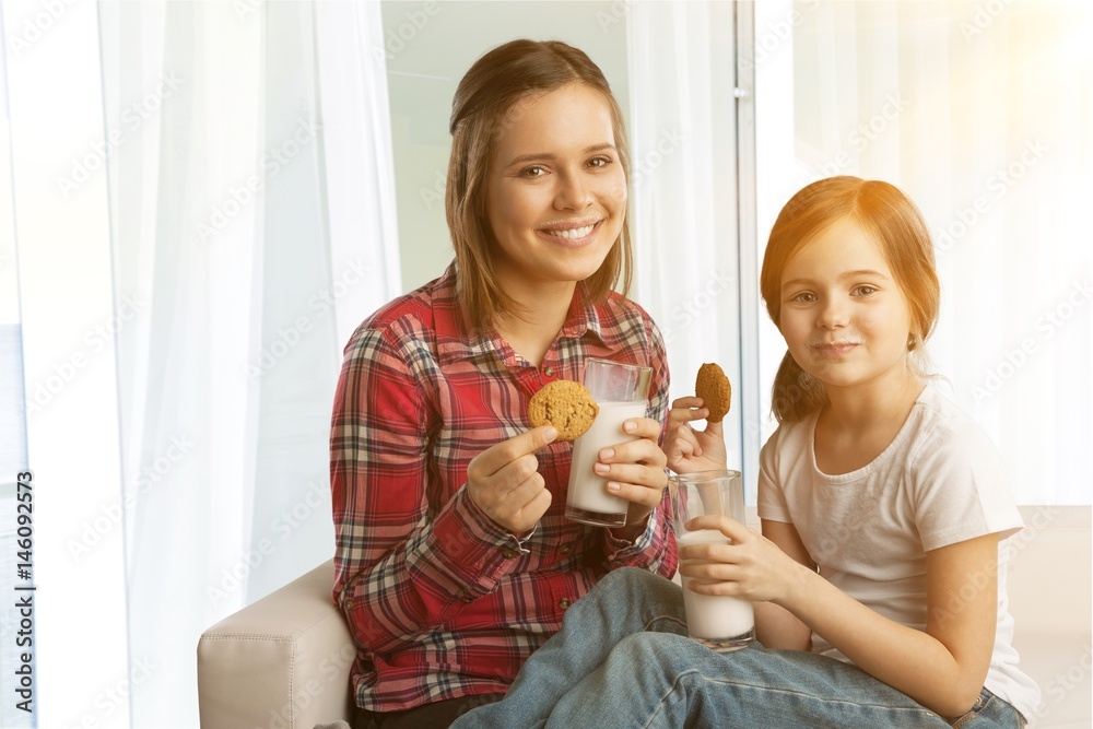 Woman and child drinking milk and eating. Woman and child drinking milk and eating.