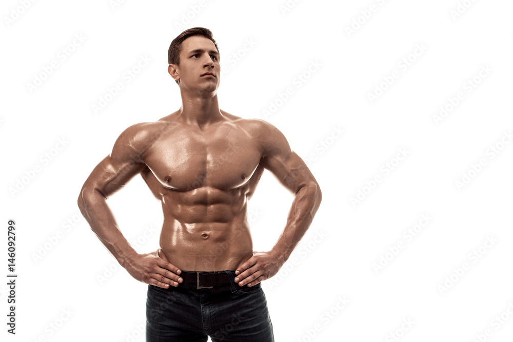 Muscular handsome young man with naked torso. Isolated on white background. Copy space