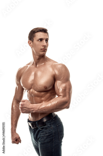Muscular handsome young man with naked torso. Isolated on white background.