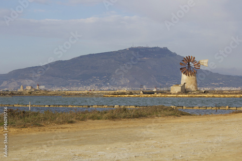 Mulino a vento alla riserva naturale orientata delle Saline di Trapani e Paceco. La riserva, all'interno della quale si esercita l'antica attività di estrazione del sale, è una importante zona umida. photo