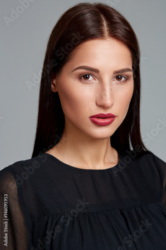 Beautiful woman face close up portrait young studio on gray