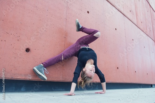 Young breakdance girl dancing breakdance on the street.