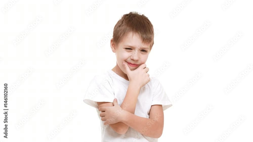 Thoughtful elementary-school aged Caucasian boy standing on white background slightly scratching chin Thoughtful elementary-school aged Caucasian boy standing on white background slightly scratching chin
