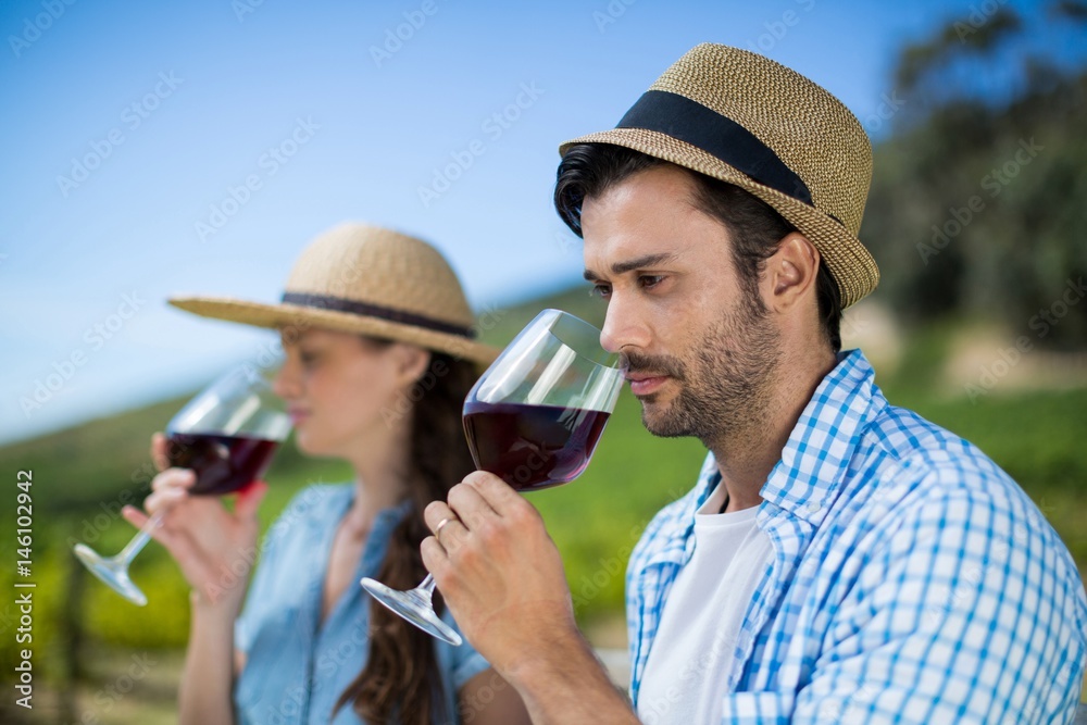Thoughtful man smelling red wine in glass Thoughtful man smelling red wine in glass
