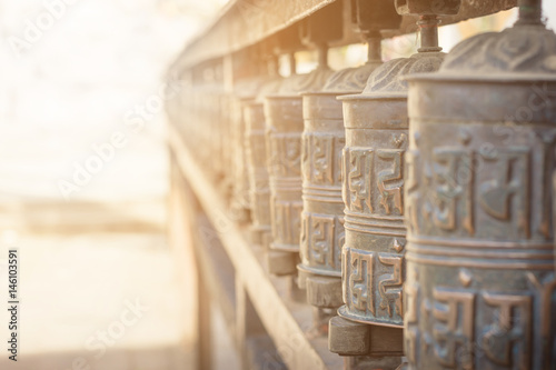 Fotografie, Obraz Background of prayer wheel in Buddhist temple in tibet with lens flare