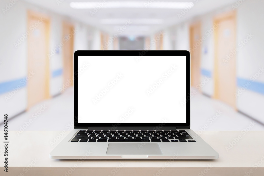 Laptop computer on medical table with hospital background Laptop computer on medical table with hospital background