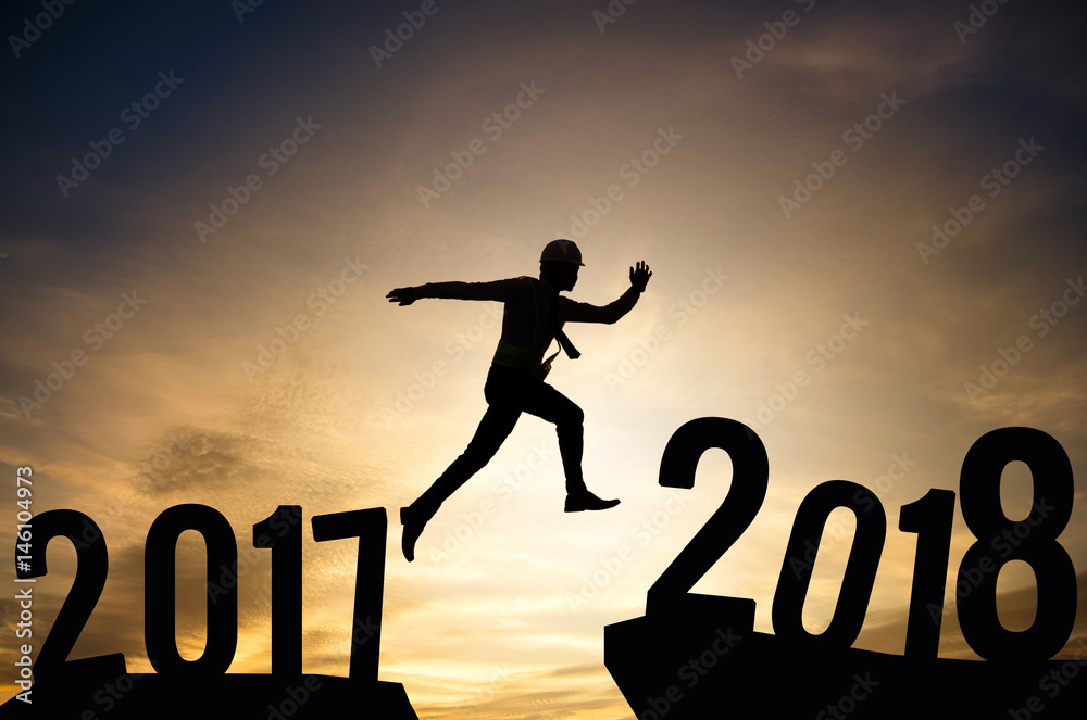 Business man or Worker jump between 2017 and 2018 years. New Year. Business man or Worker jump between 2017 and 2018 years. New Year.
