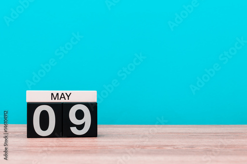 May 9th. Day 9 of month, calendar on turquoise background. Spring time, empty space for text. Symbols Of the victory in World War II