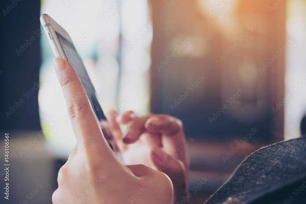 A business woman holding and touching smart phone in modern cafe A business woman holding and touching smart phone in modern cafe