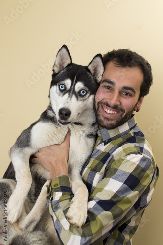 Young man with beautiful siberian husky.