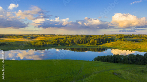Drone flight over the lake and the fields