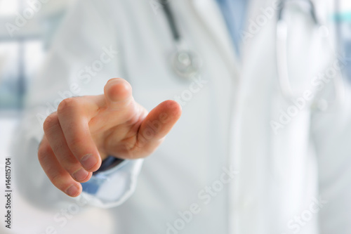 Finger of a doctor holding at you