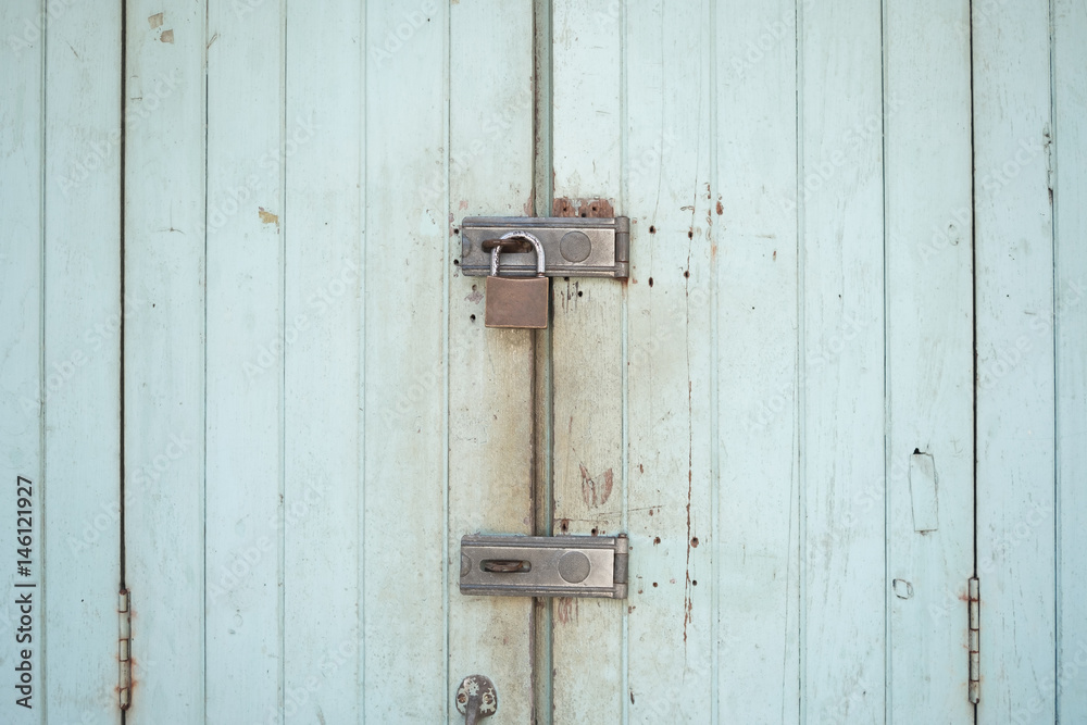 Locks on rusty wooden door.Nobody's home concept.