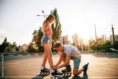 Naklejka a couple roller-skating at sunset