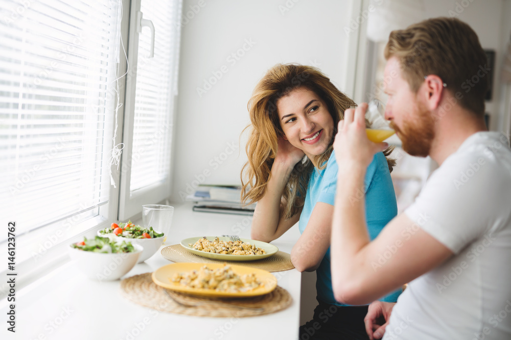 Couple having breakfast in the morning and smiling Couple having breakfast in the morning and smiling