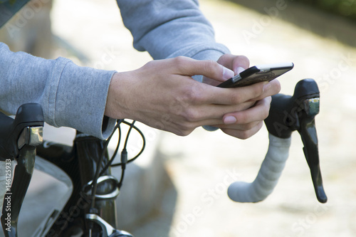 young man with the mobile phone and the bike