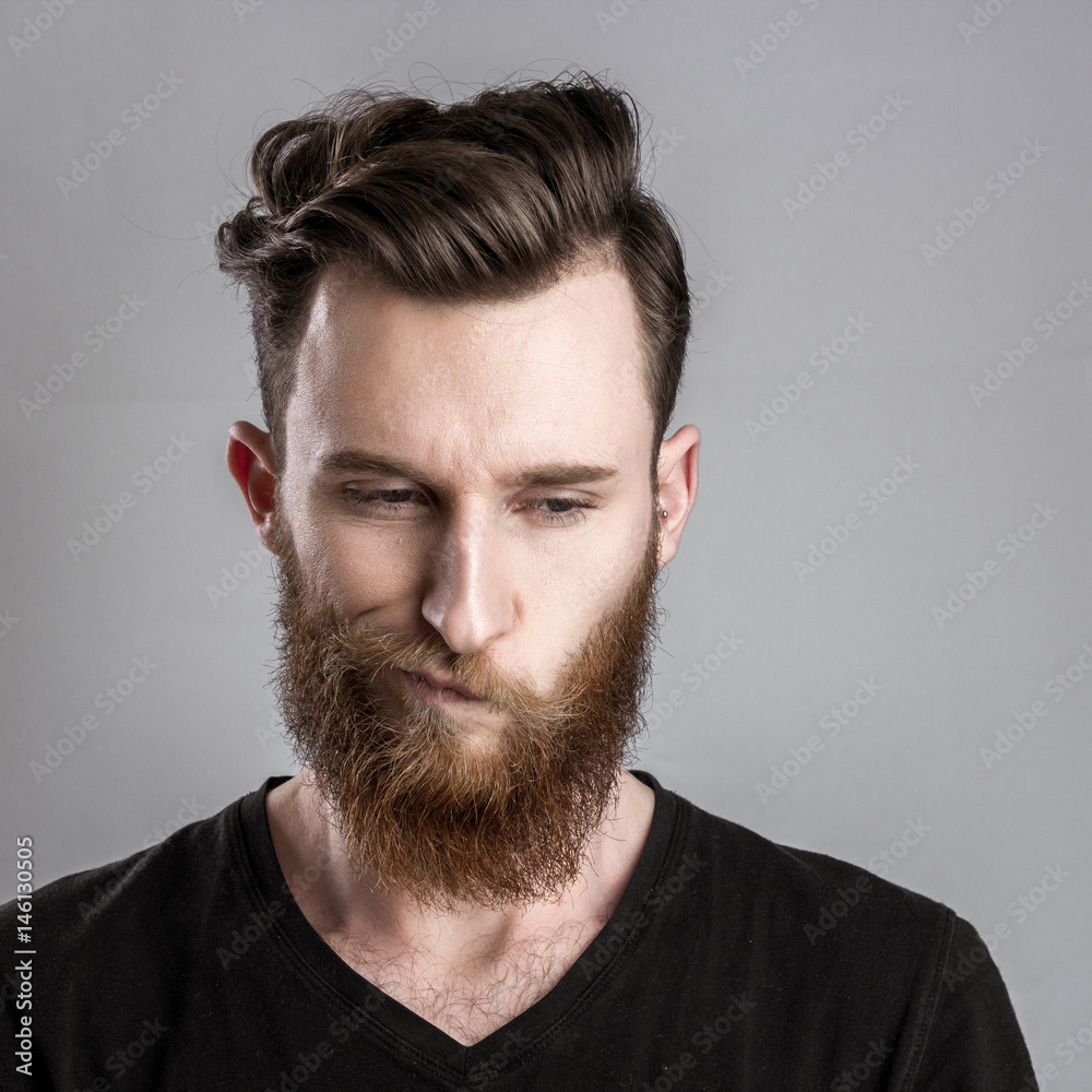 Fototapeta premium Unconfident and worried young man isolated on gray background