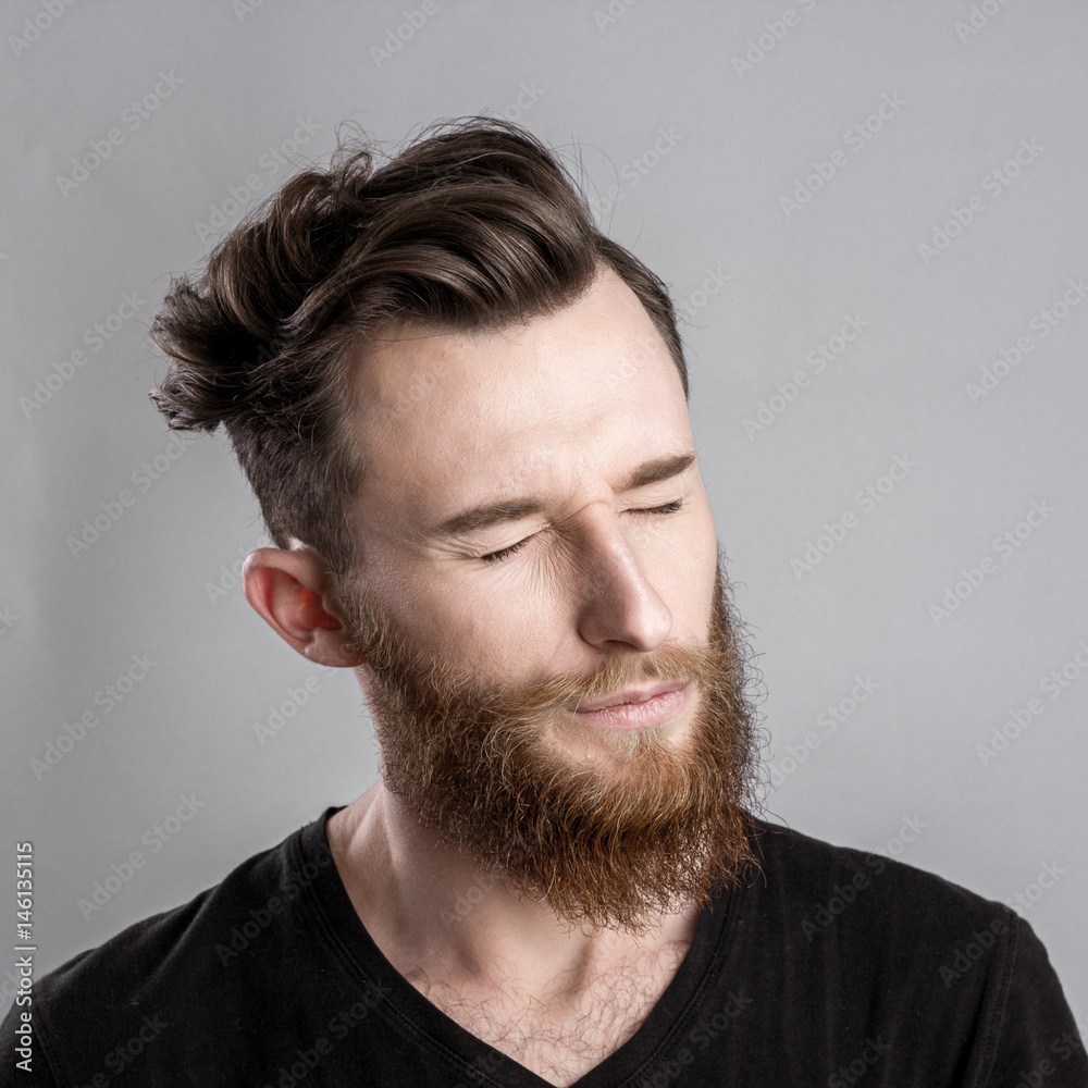 Fototapeta premium Shocked and worried young man isolated on gray backround