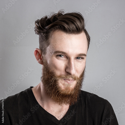 Quadro em tela Shy young man isolated on gray backround