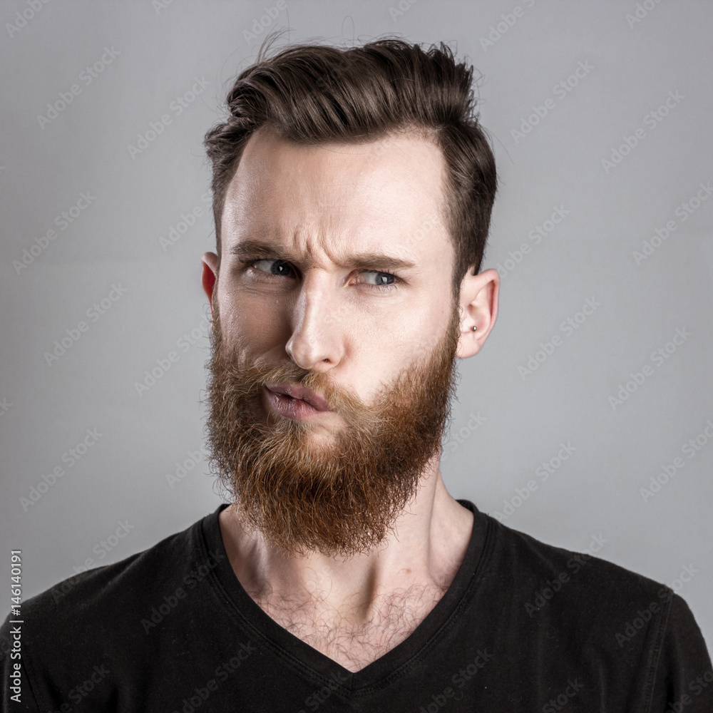 Fototapeta premium Unconfident and worried young man isolated on gray background