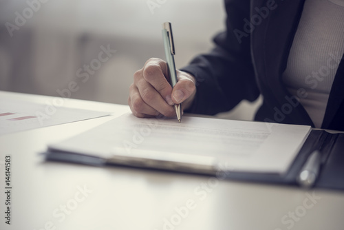 Businesswoman signing a contract or document photo