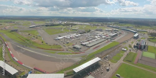 Aerial view of a big race on a sunny summer day in England. Cars going along the race. Full campsite. photo