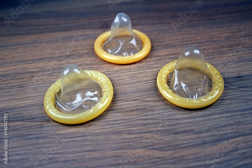 Condoms on wooden background