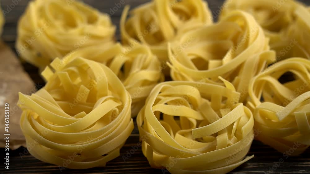 pasta and flour on wooden background pasta and flour on wooden background