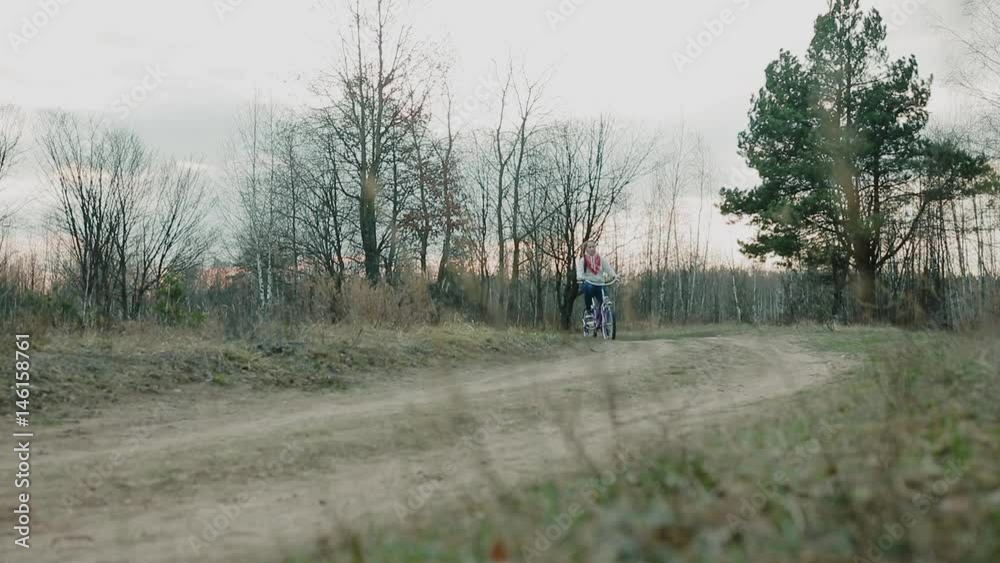 young beautiful woman riding a bicycle in a park young beautiful woman riding a bicycle in a park