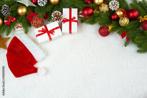 christmas decoration on fir tree branch closeup  gifts  xmas ball  cone and other object on white blank space fur  holiday concept  place for text