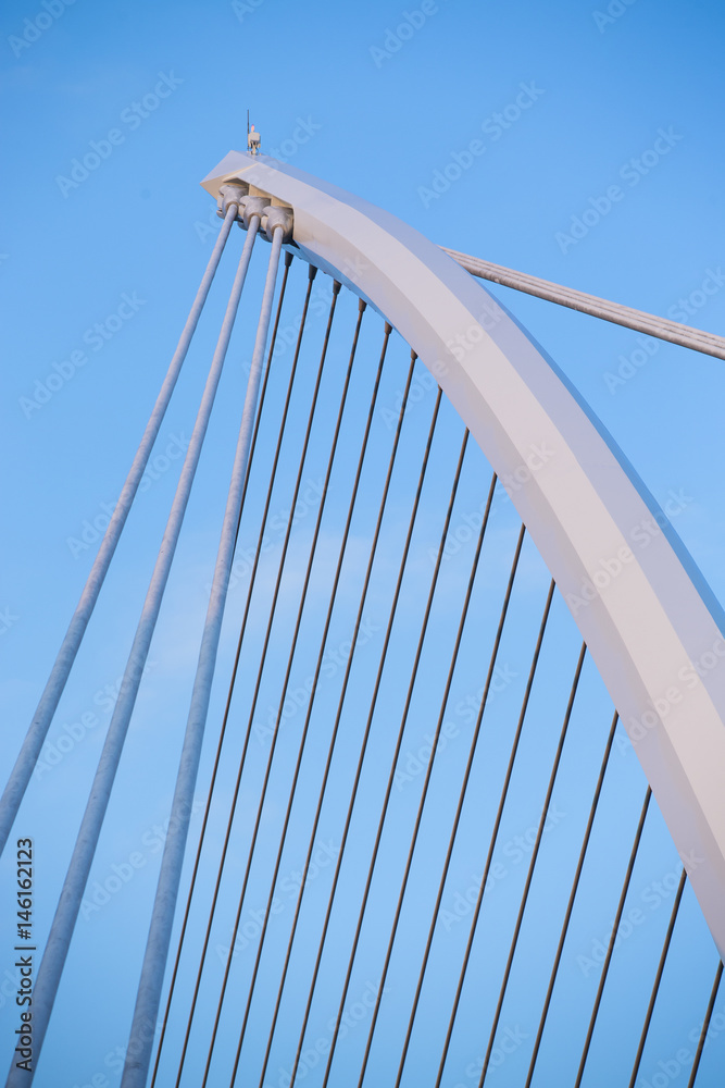 Obraz premium The Samuel Beckett Bridge crosses the Liffey River in Dublin. The structure, designed with a cable-stay method of suspension, is said to resemble an Irish harp.