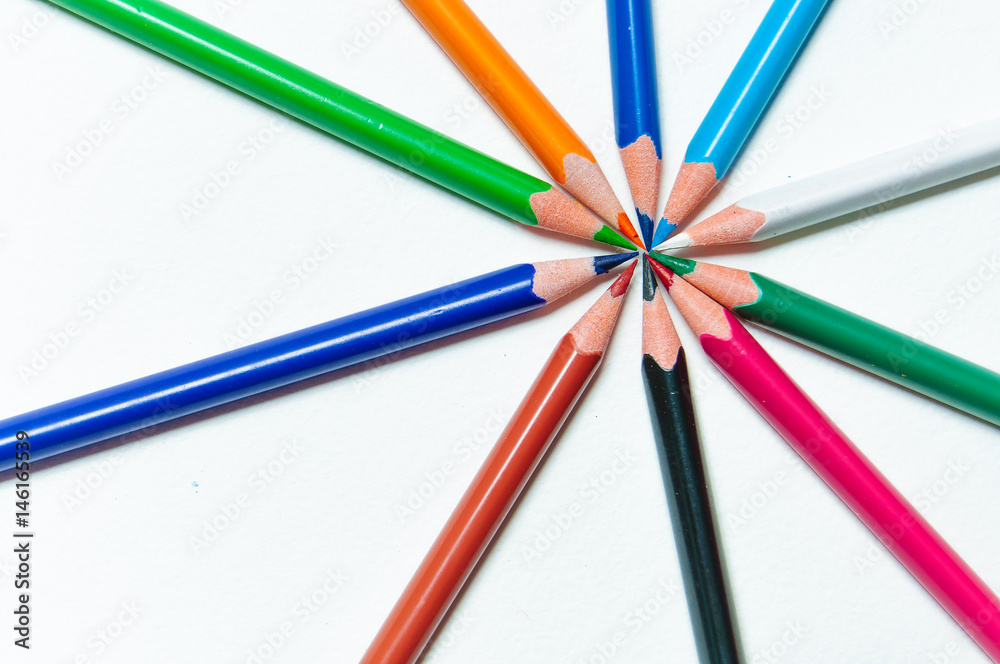 Many different colored pencils on paper background. Many different colored pencils on paper background.