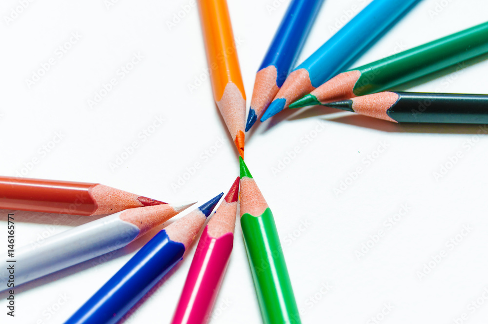 Naklejka premium Many different colored pencils on paper background.