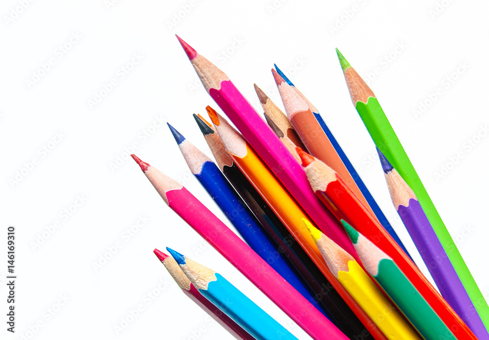 Many different colored pencils on paper background. Many different colored pencils on paper background.