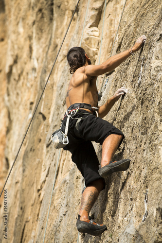 Young man climbing on a wall