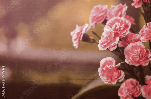 Obraz na plátně pink carnations blended with hard wood panel for background, filtered tones