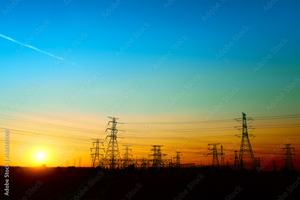 High voltage towers, under the setting sun