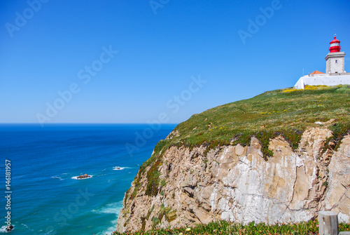 Cape Roca, Portugal with famous lighthouse on the edge of a cliff and view of Atlantic ocean