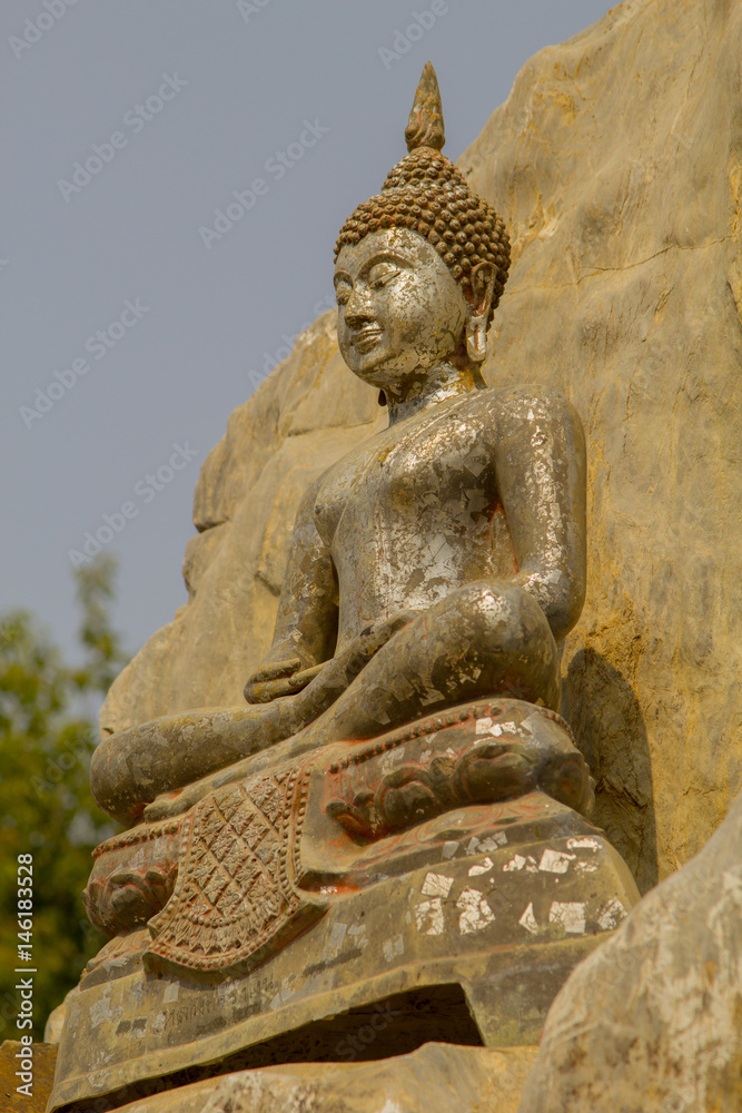 Fototapeta premium Buddha statue on the hill in buddhist temple at Wat Mai Kham Wan temple, Phichit,Thailand.