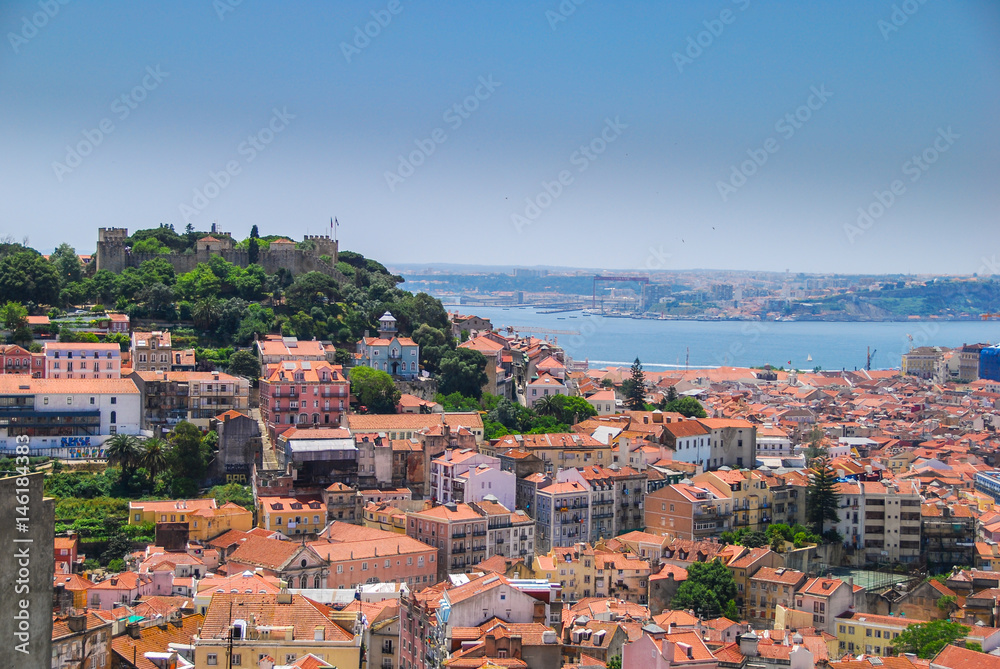 Lisbon skyline with fortress on the hill viewed from famous viewpoint