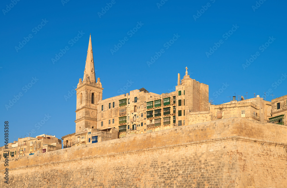 An old sandstone church and houses in Valetta, Malta
