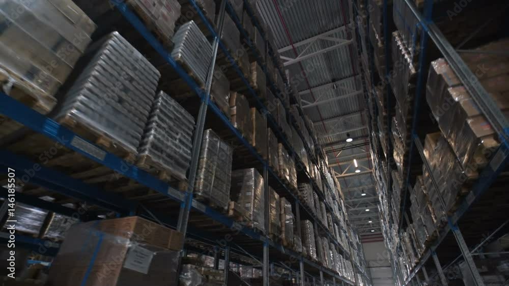Logistics business and shipping facility with forklifts to move boxes and parcels. cardboard boxes inside a storage warehouse Logistics business and shipping facility with forklifts to move boxes and parcels. cardboard boxes inside a storage warehouse