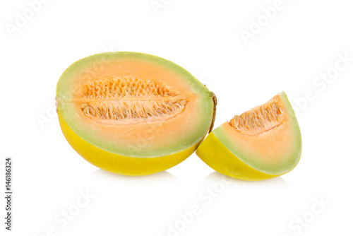 portion cut fresh yellow melon with stem on white background