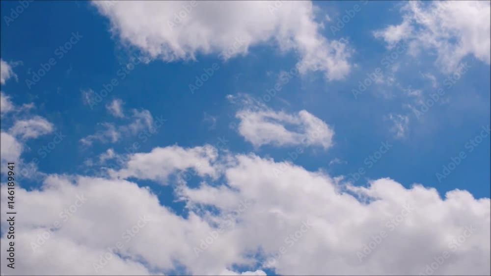 White clouds move across clear blue sky. Cloudy blue sky background. White clouds move across clear blue sky. Cloudy blue sky background.